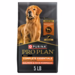 Purina Pro Plan dog food kibble poured into a metal bowl next to the bag